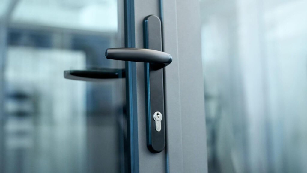 Close-up of matte black uPVC door handles on a premium glass door in a contemporary home setting.
