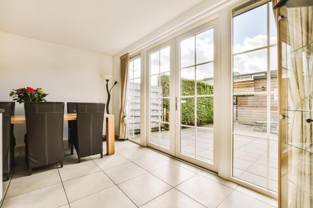 Classic white uPVC doors with glass panels, ideal for dining areas and long-lasting performance in Indian homes.